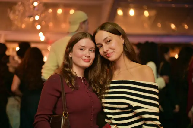 Two friends posing together at an event
