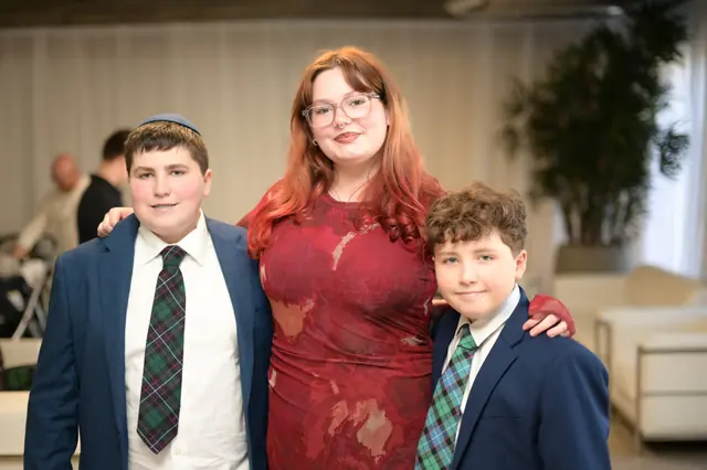Three young guests in formal wear at a celebration